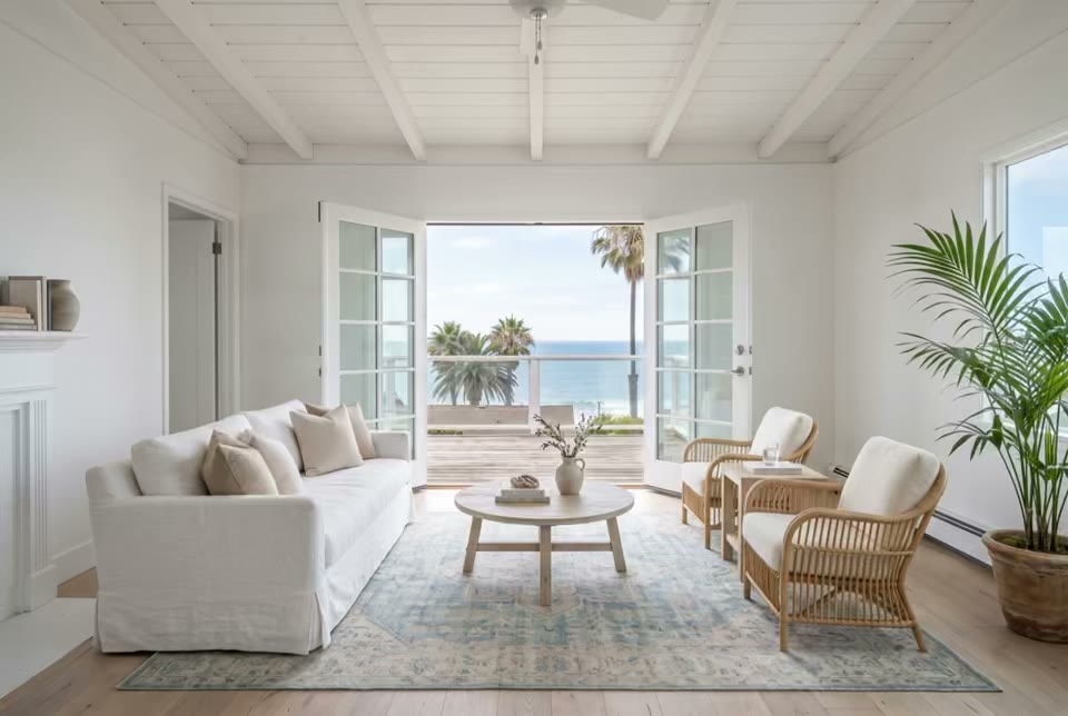 Staged living room opening to a patio