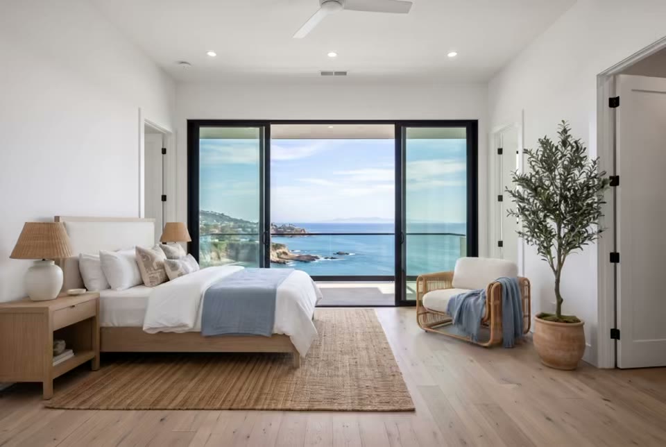 Staged bedroom with an ocean view